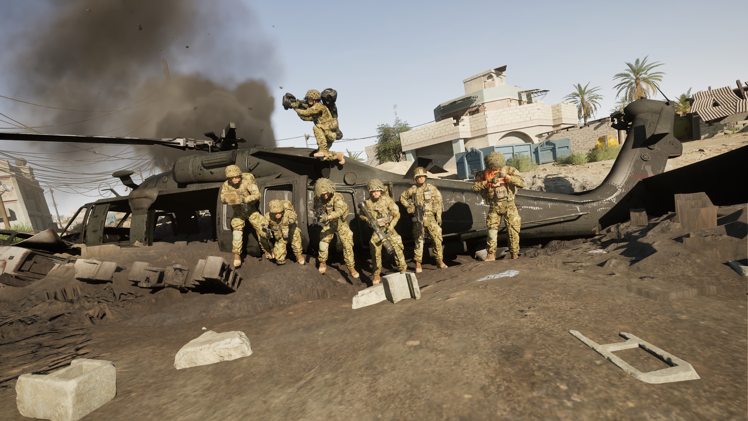 Squad posing on a downed Black Hawk helicopter
