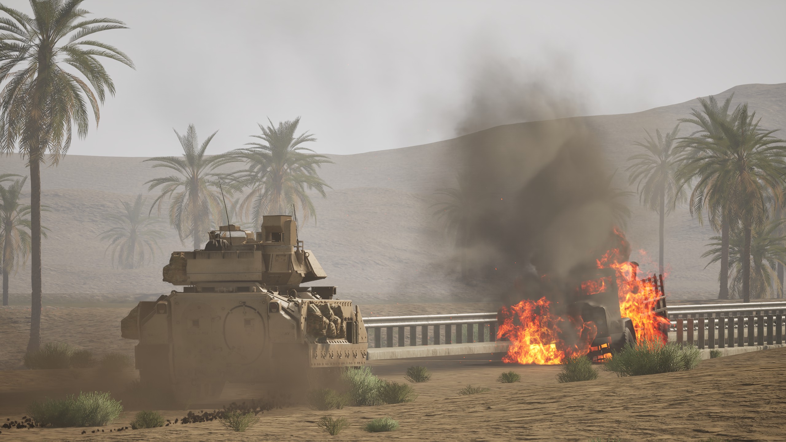 Bradley IFV passing a burning vehicle in the desert