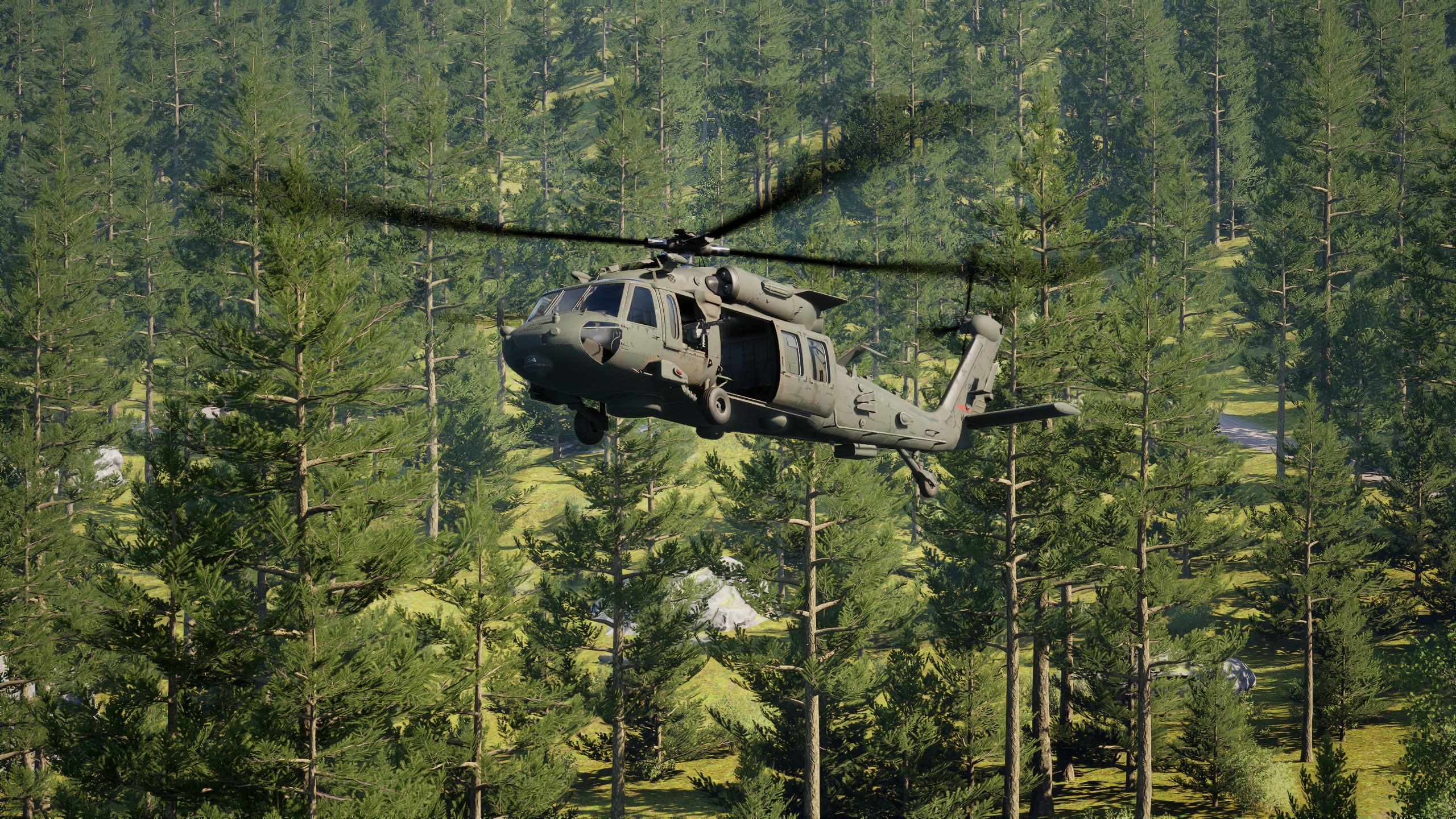 Black Hawk helicopter flying low over dense forest